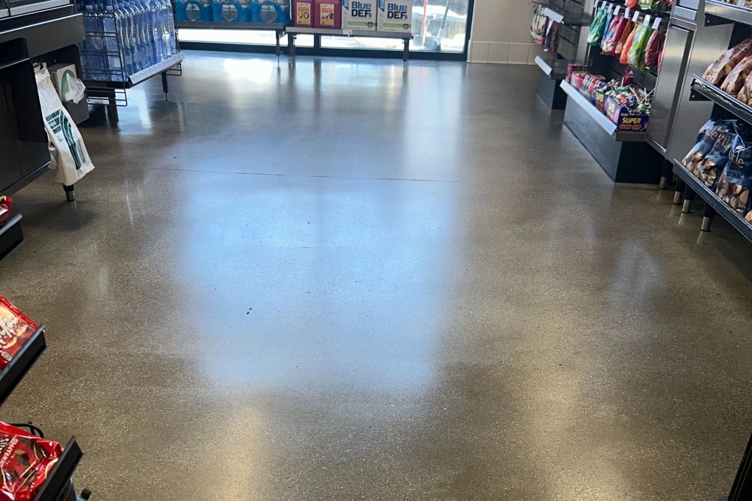 Concrete floor in a Los Angeles retail store after professional cleaning and sealing by StoneShine, showcasing a glossy finish and enhanced durability.