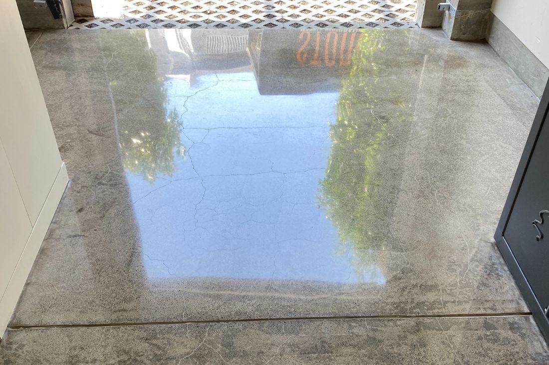 Polished concrete floor in Dana Point showcasing a smooth, reflective finish achieved through professional grinding and polishing services.