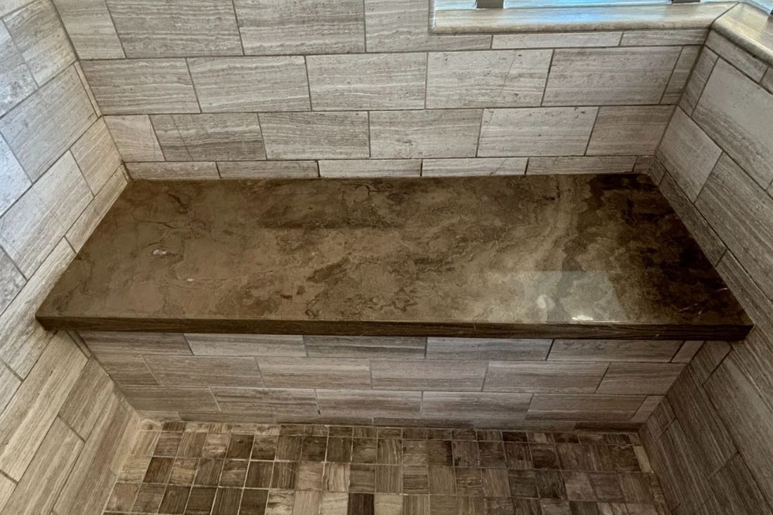 Polished limestone bench in Newport Beach shower after StoneShine's restoration