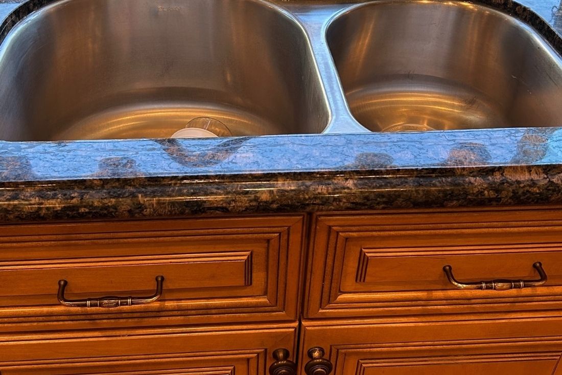 A close-up of a granite kitchen countertop after StoneShine's crack repair service in Newport Beach. The surface is smooth, polished, and seamlessly restored.